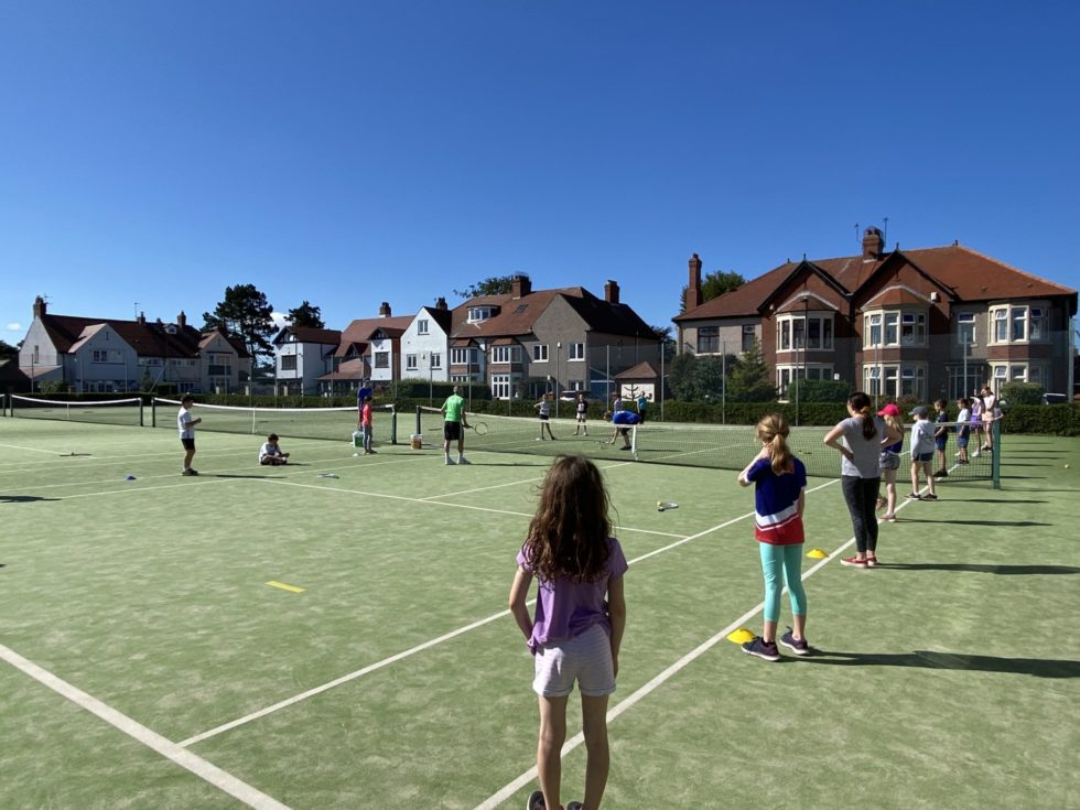 Junior tennis coaching session